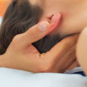 Tuina massage being carried out on the neck of a young woman